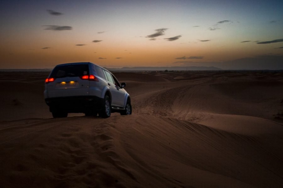 white SUV on desert during daytime